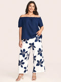 Completo estivo da donna con blusa a spalle scoperte tinta unita e pantaloni con stampa floreale, adatto per taglie forti
