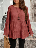 Blusa plissettata minimalista a maniche lunghe e collo rotondo, tinta unita
