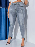 Jeans skinny strappati vita alta