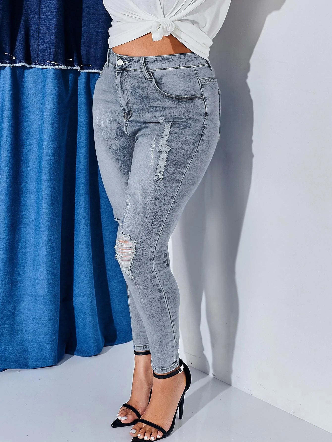 Jeans skinny strappati vita alta